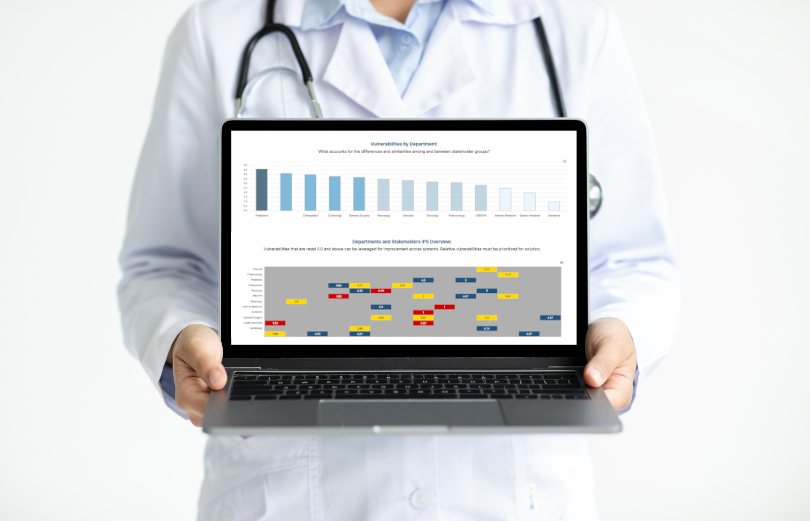 An image of a person holding a laptop, which displays helpful information VitalInsight can provide.